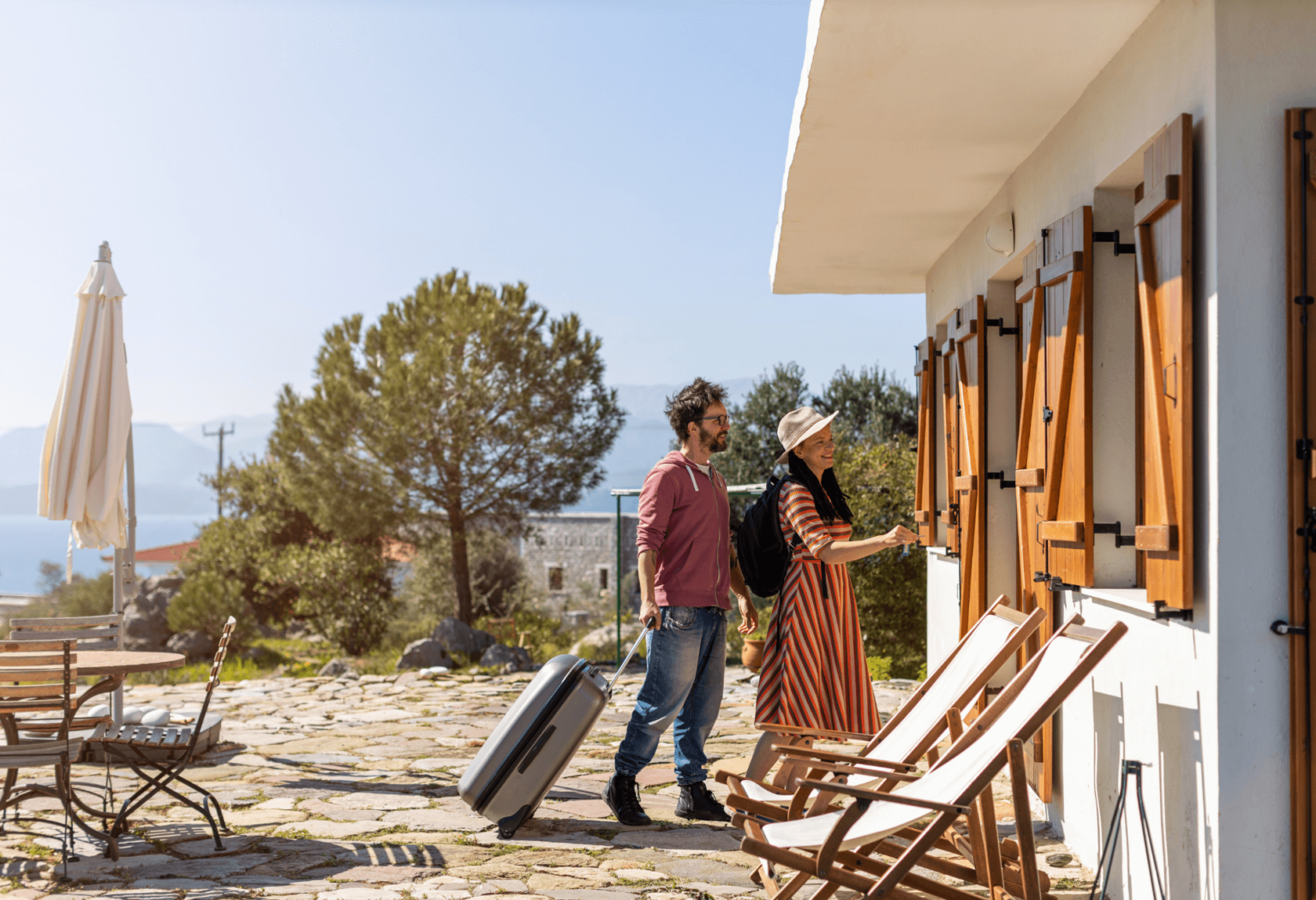 man and woman unlocking the door to a short term rental airbnb
