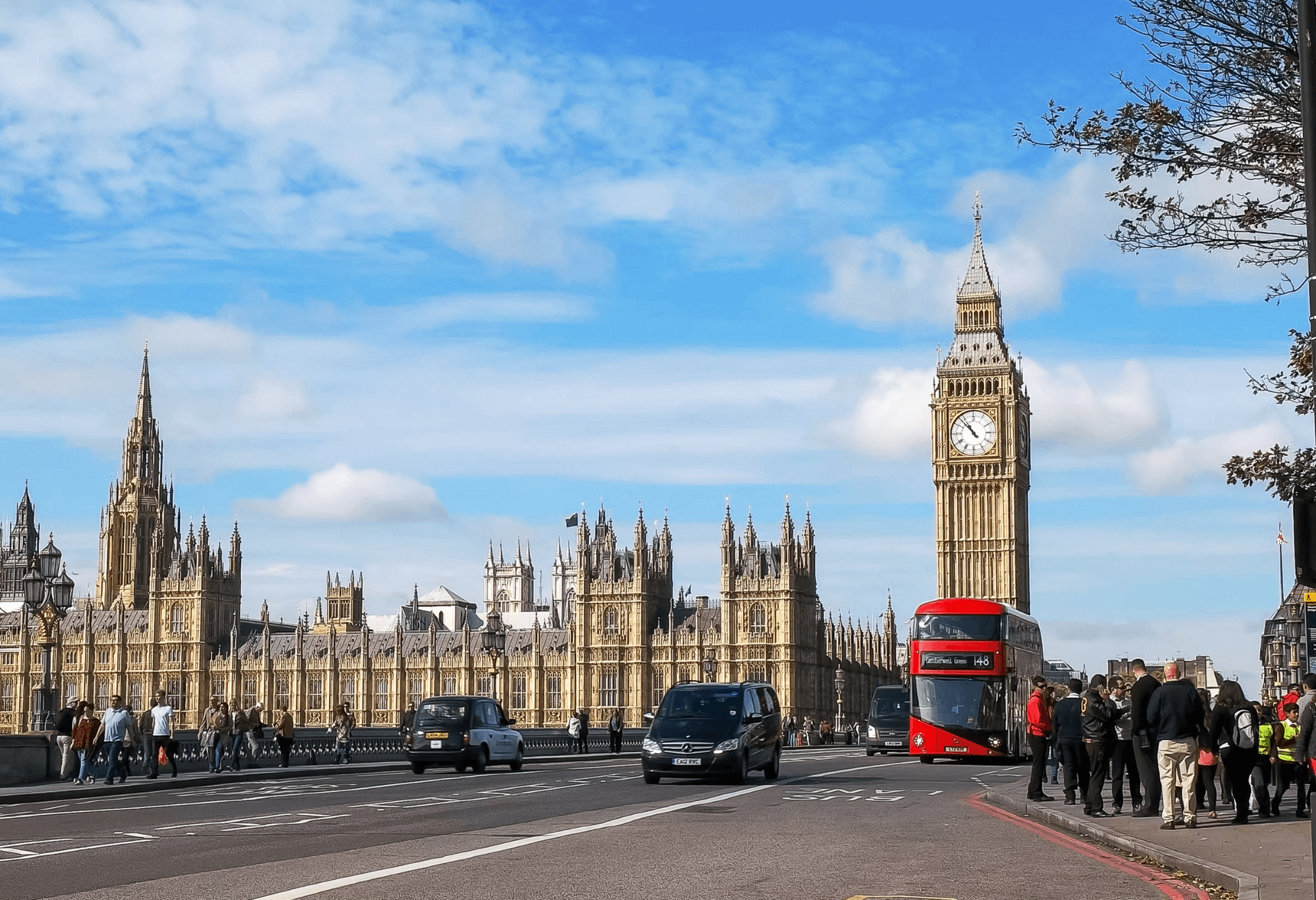 Photo of a London street with a red double decker bus in the foreground and Big Ben in the background