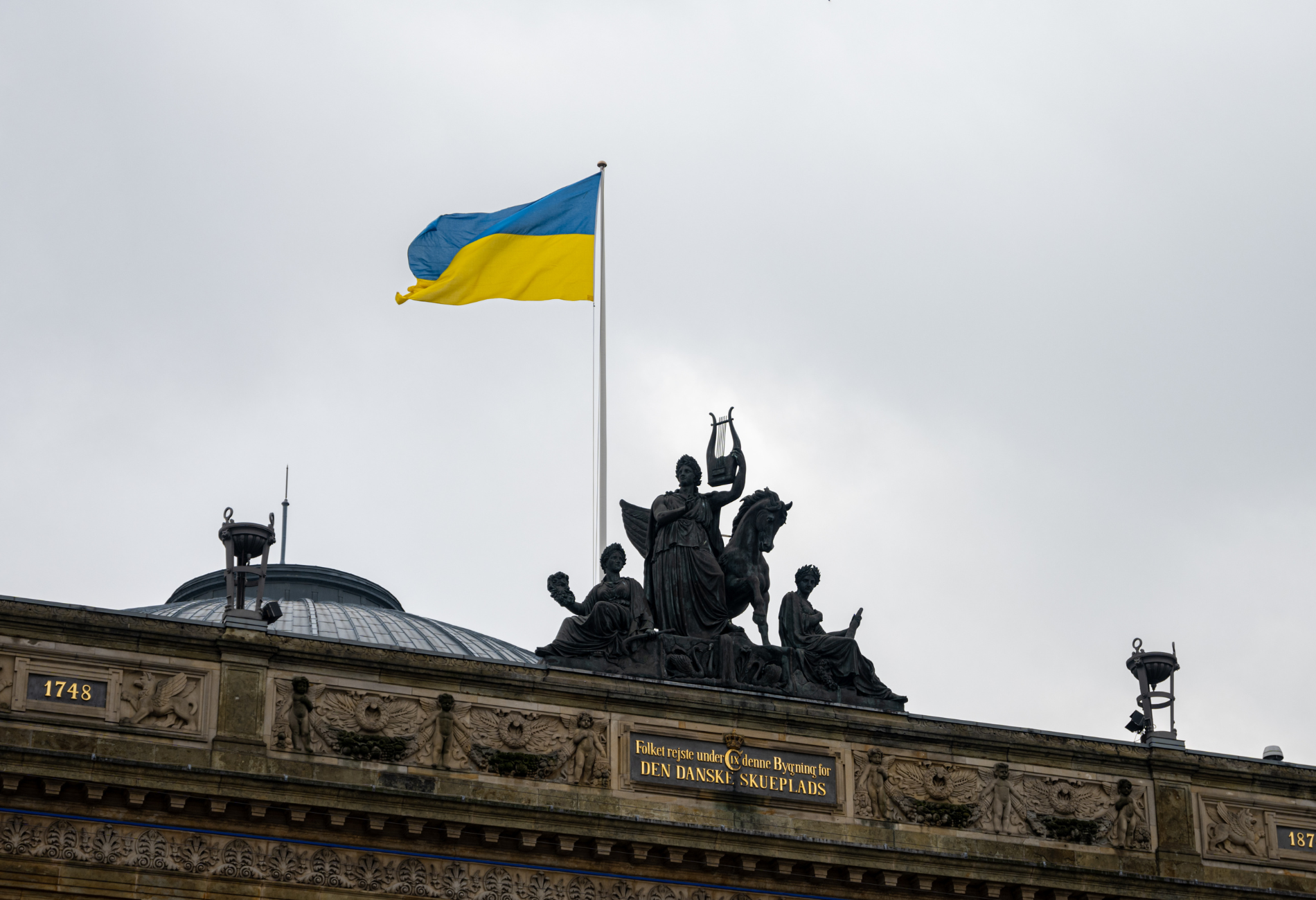 ukranian flag waving against a dreary sky