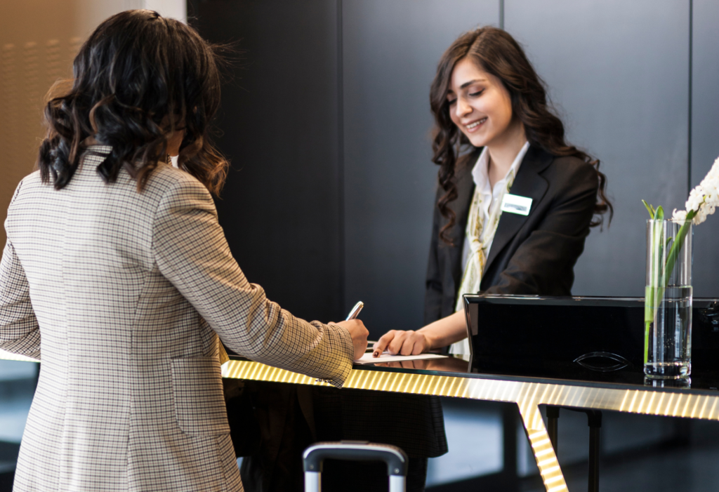 hotel staff member welcomes guest