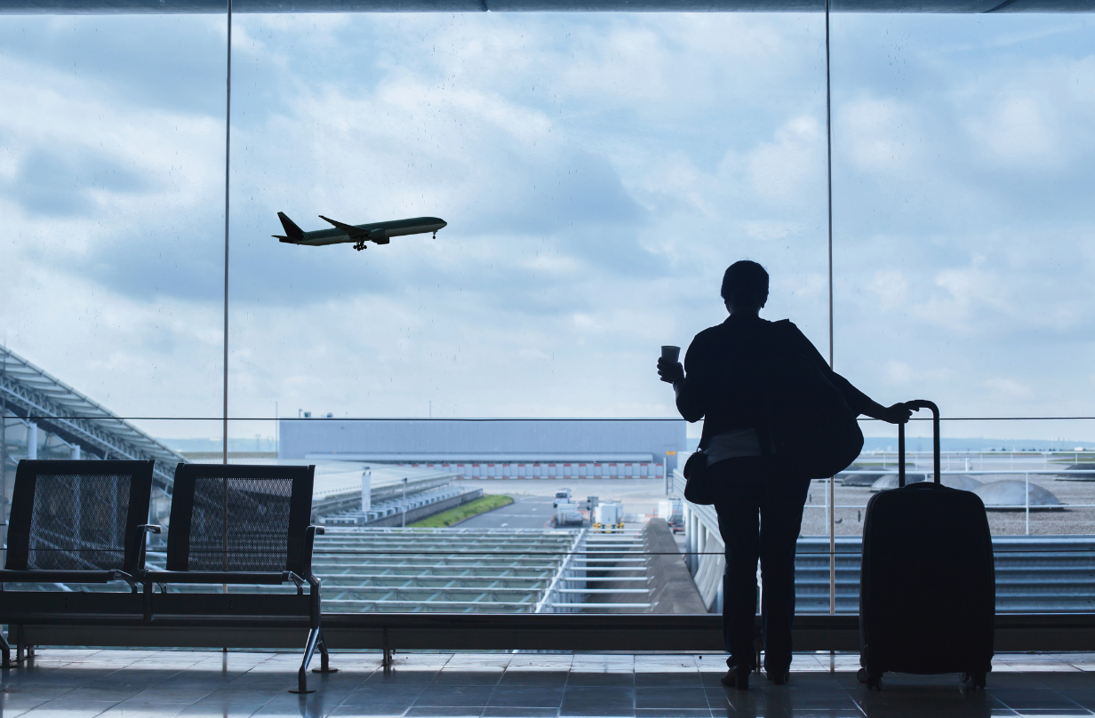 woman watching plane takeoff