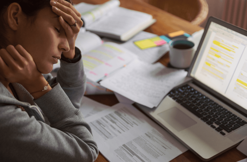 burnt out employee leaning over computer