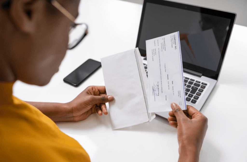 woman looking at paycheck