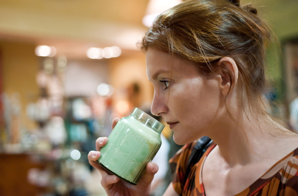 woman smelling candle