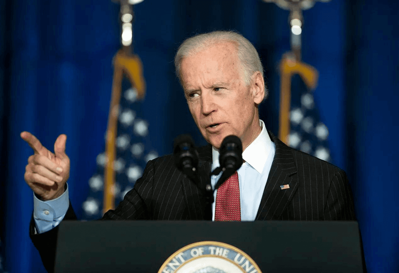 biden pointing while giving speech behind podium