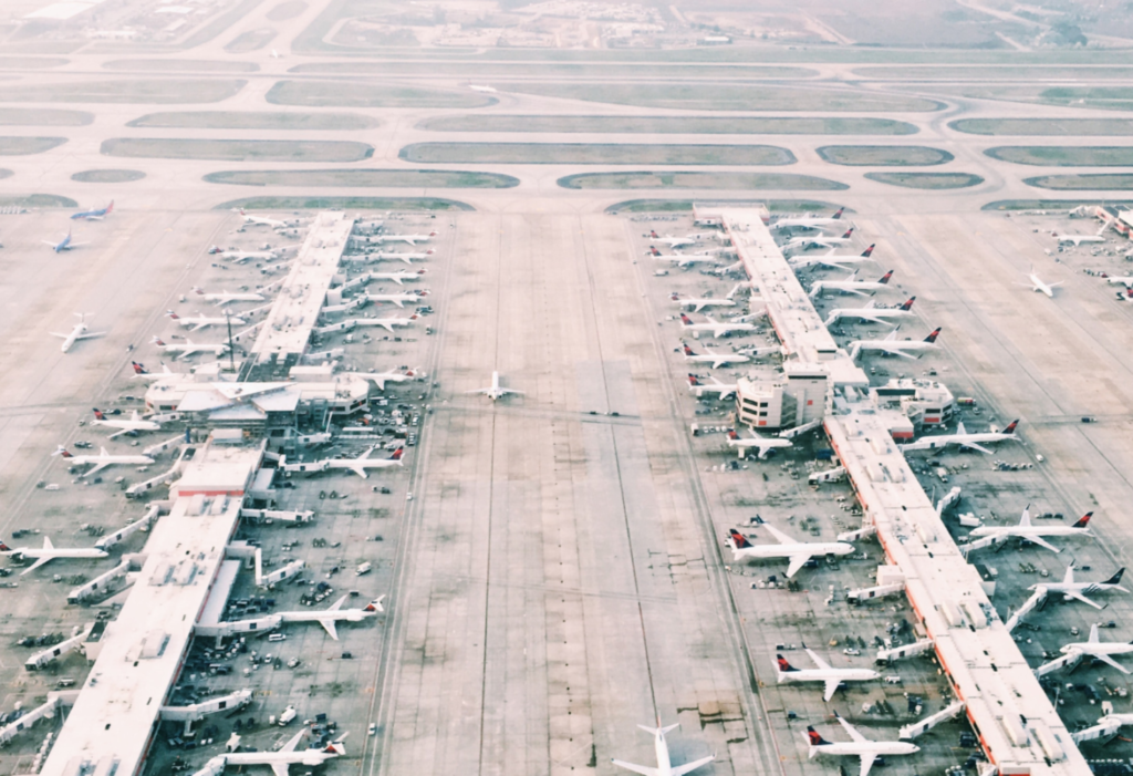 a bunch of airplanes grounded at airport