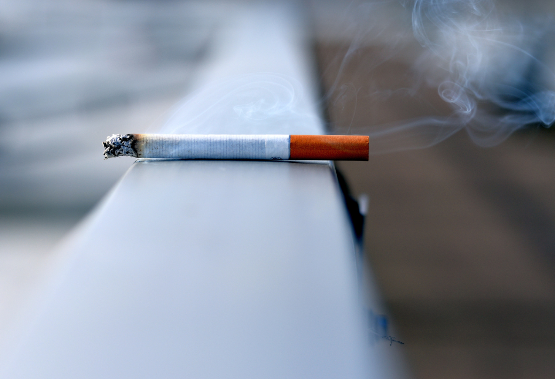 burning cigarette on ledge