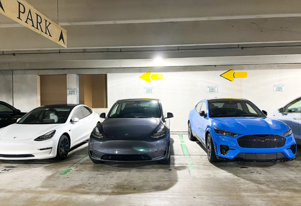 Cars backed into parking spaces in parking garage