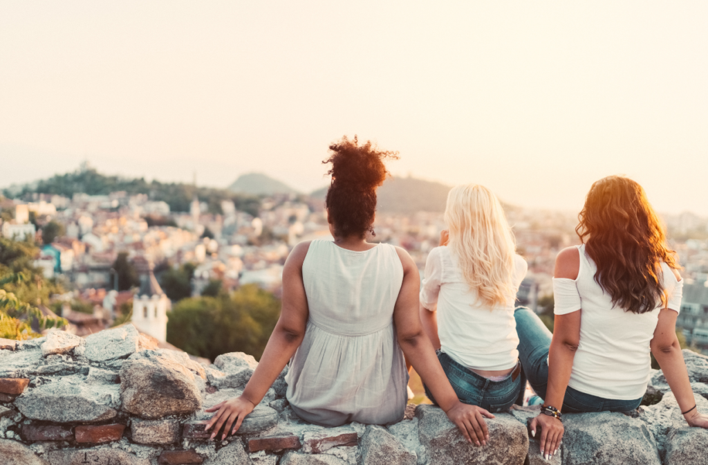 three women enjoying the view with backs turned