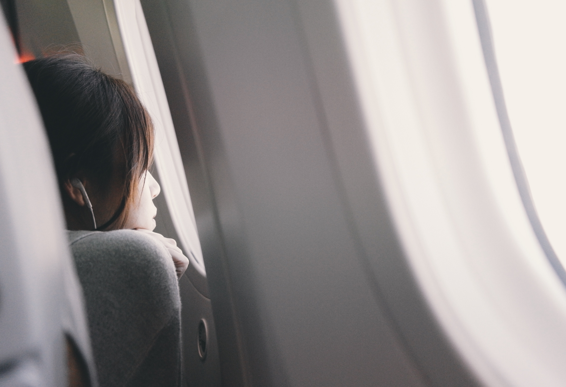 Child staring out plane window