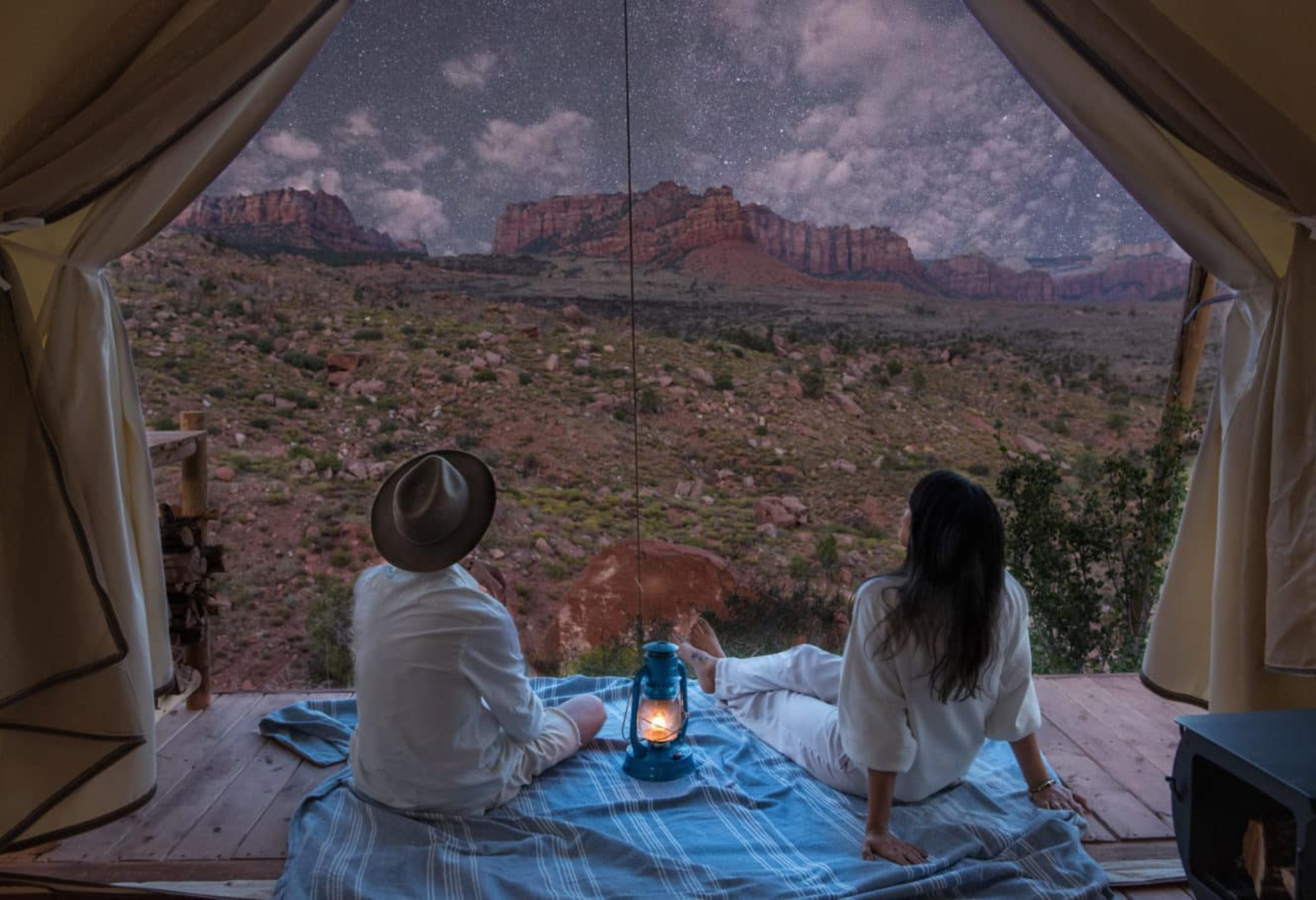 Two people looking out from their glamping tent for options on where to stay in Zion National Park