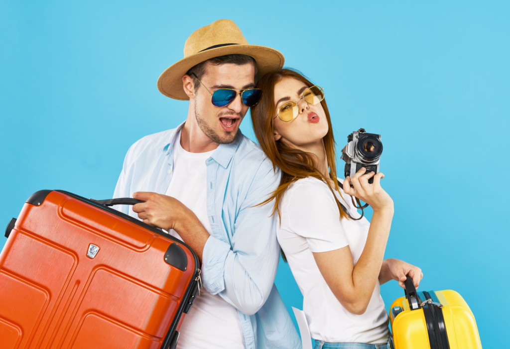 man and woman holding luggage