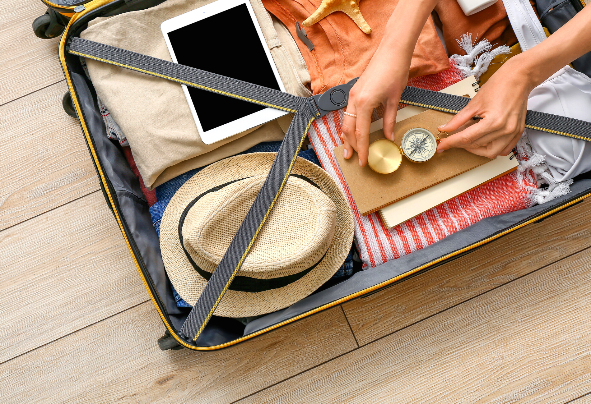 open luggage with hands arranging items