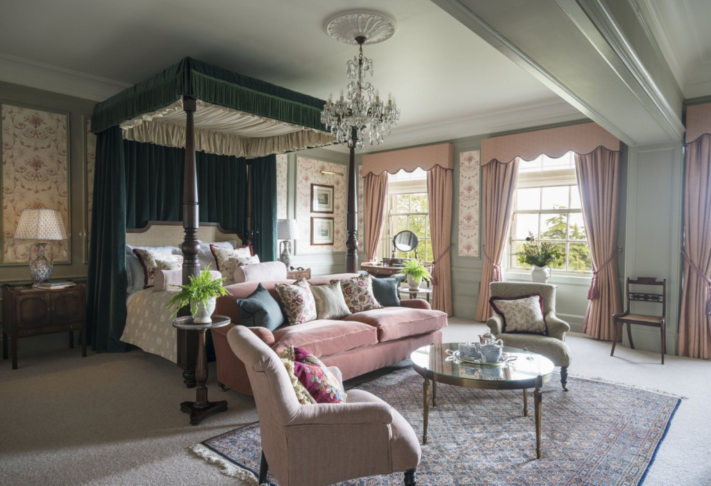 guest room at Gleneagles with canopy bed, sitting room area and bay windows