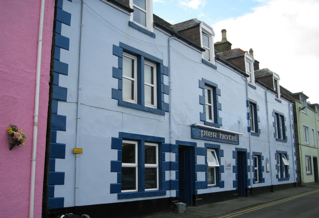 blue building, the exterior of The Pier Hotel