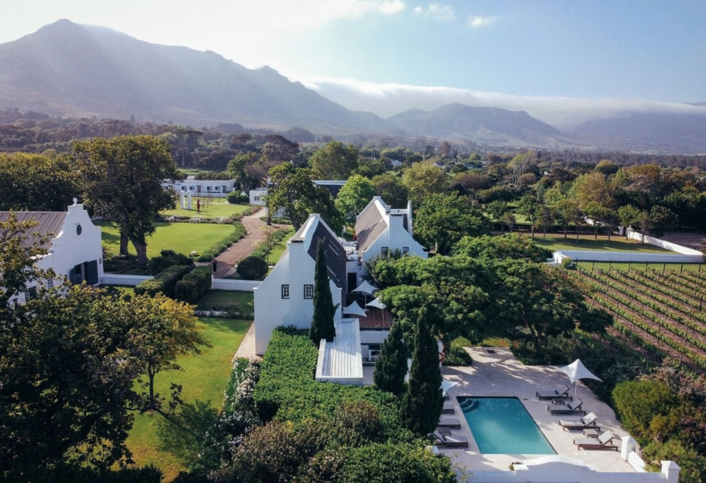 farmhouse with a pool and lush greenery abound