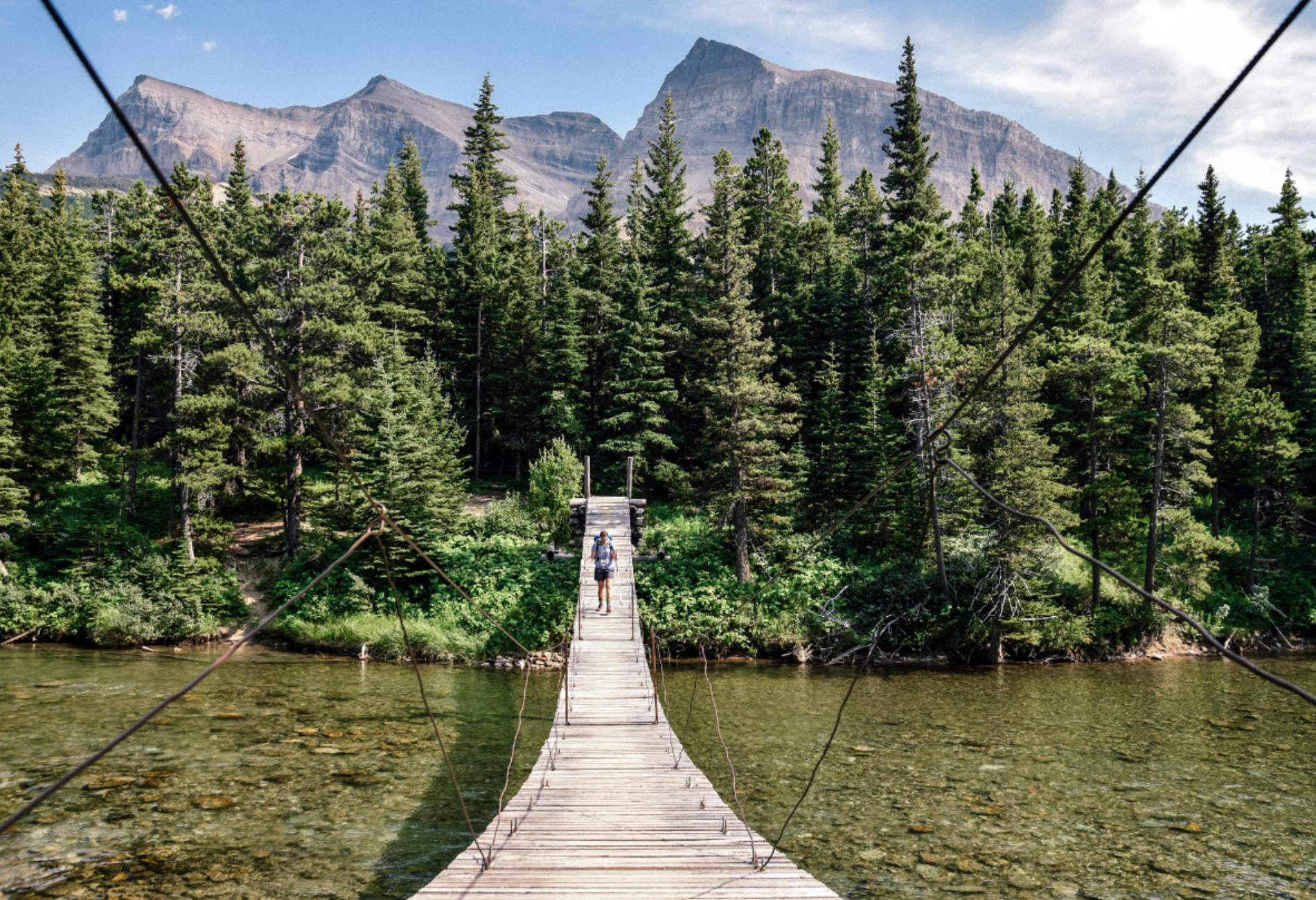 bridge with a person on it and mountains in the background for a story on Google Maps