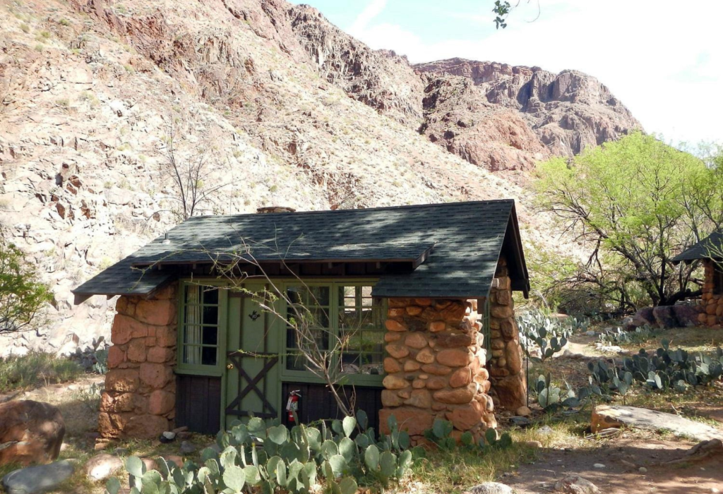 rustic building with mountains in the back