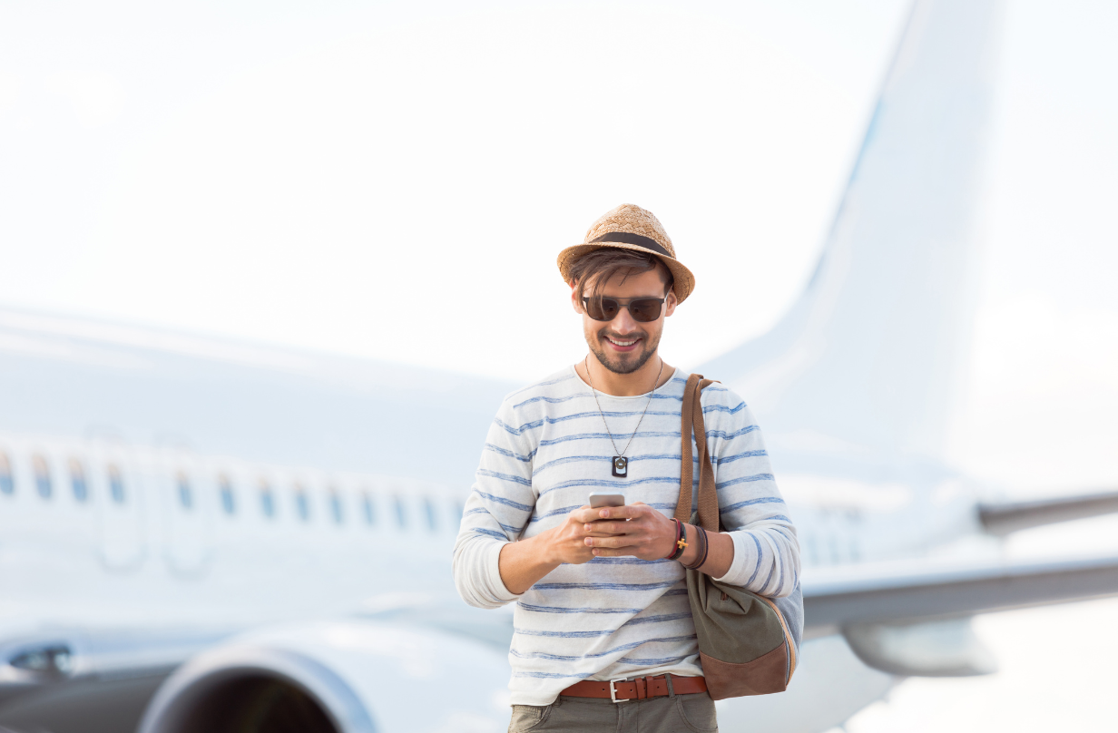 man summer travel on phone with plane in background