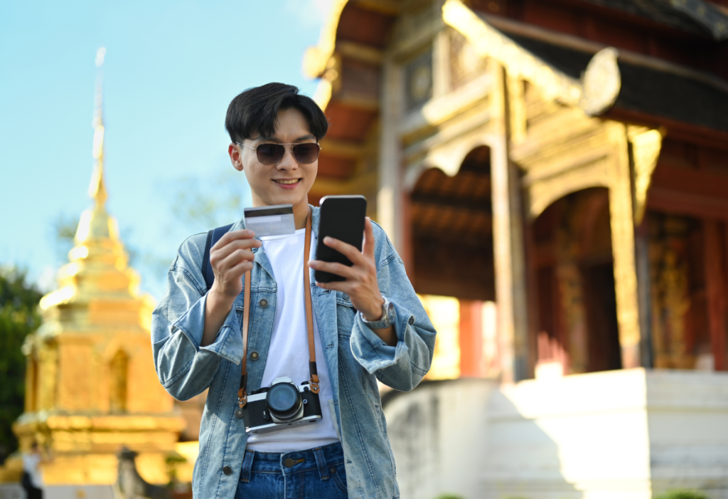 Man holding credit card while on vacation, for the Capital One Venture review