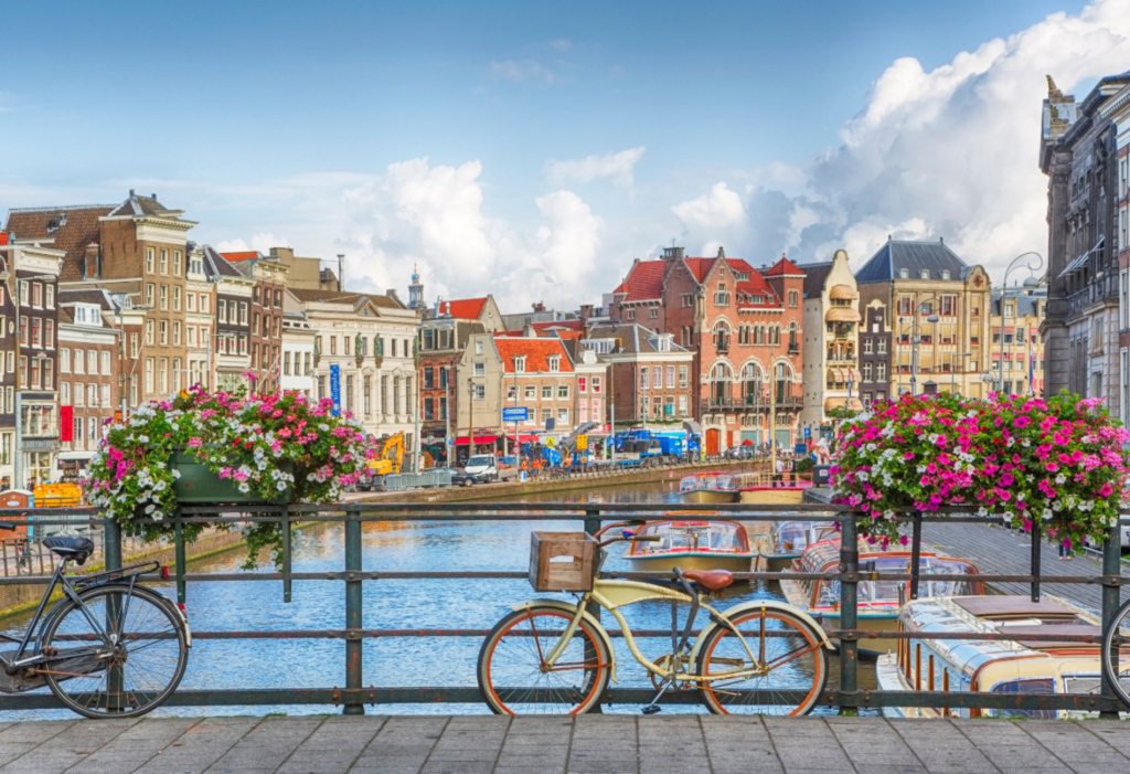 city of Amsterdam with colorful buildings, river, and a bike