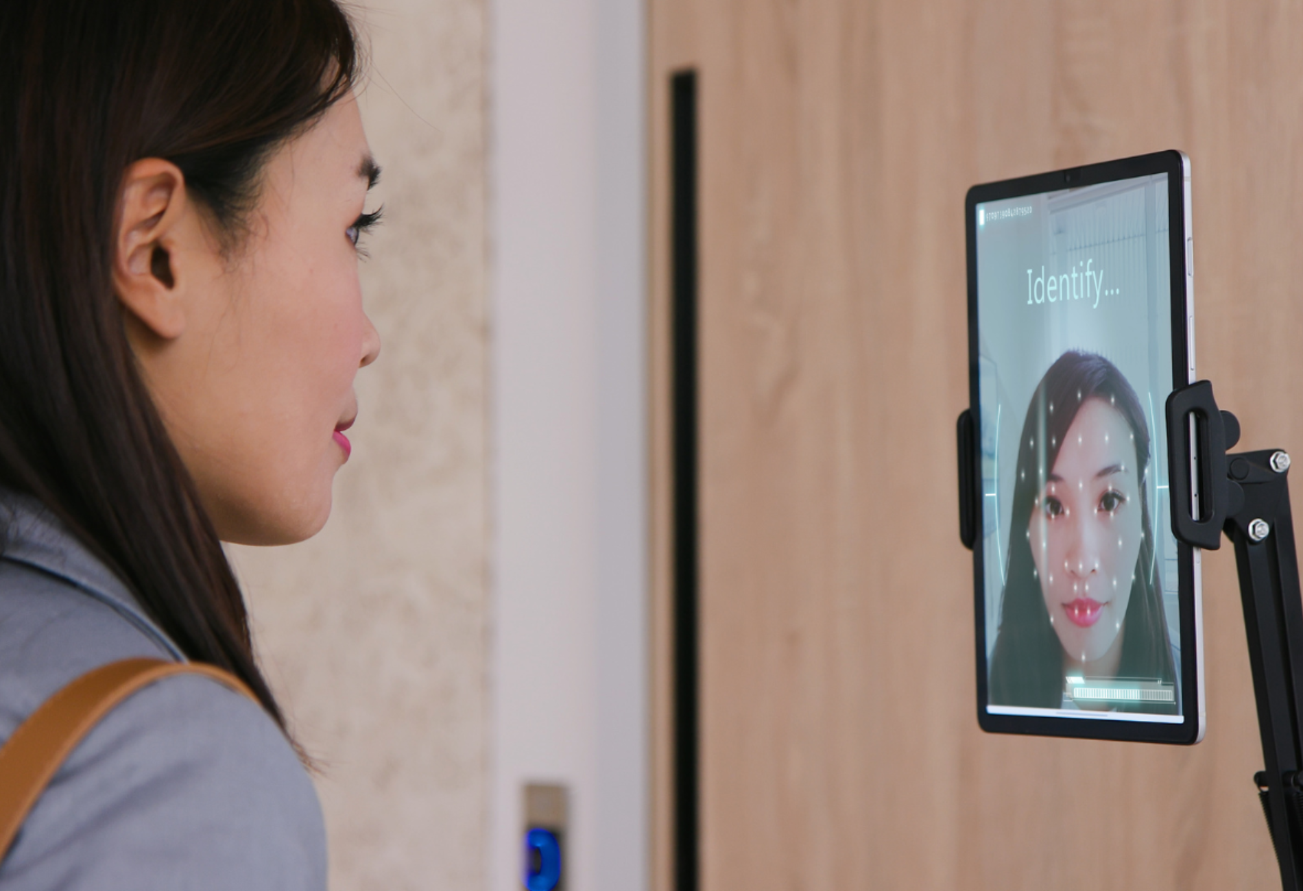 woman staring at screen for facial recognition technology