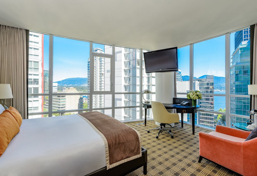 interior of hotel room with floor-to-ceiling windows overlooking city for article on the best hotels in Vancouver