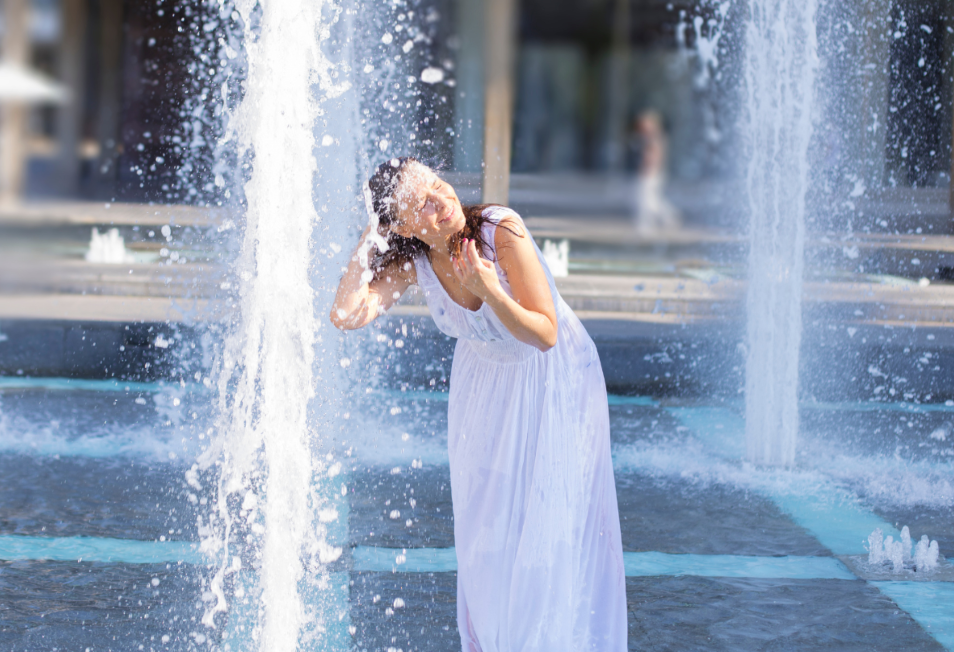 woman cooling off at fountain