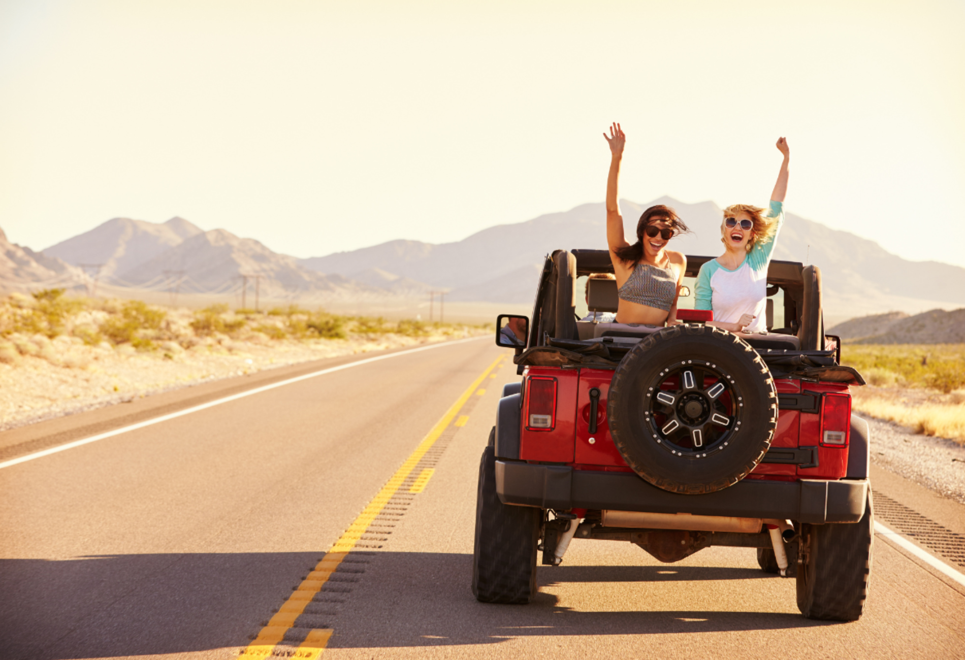 people waving in a jeep