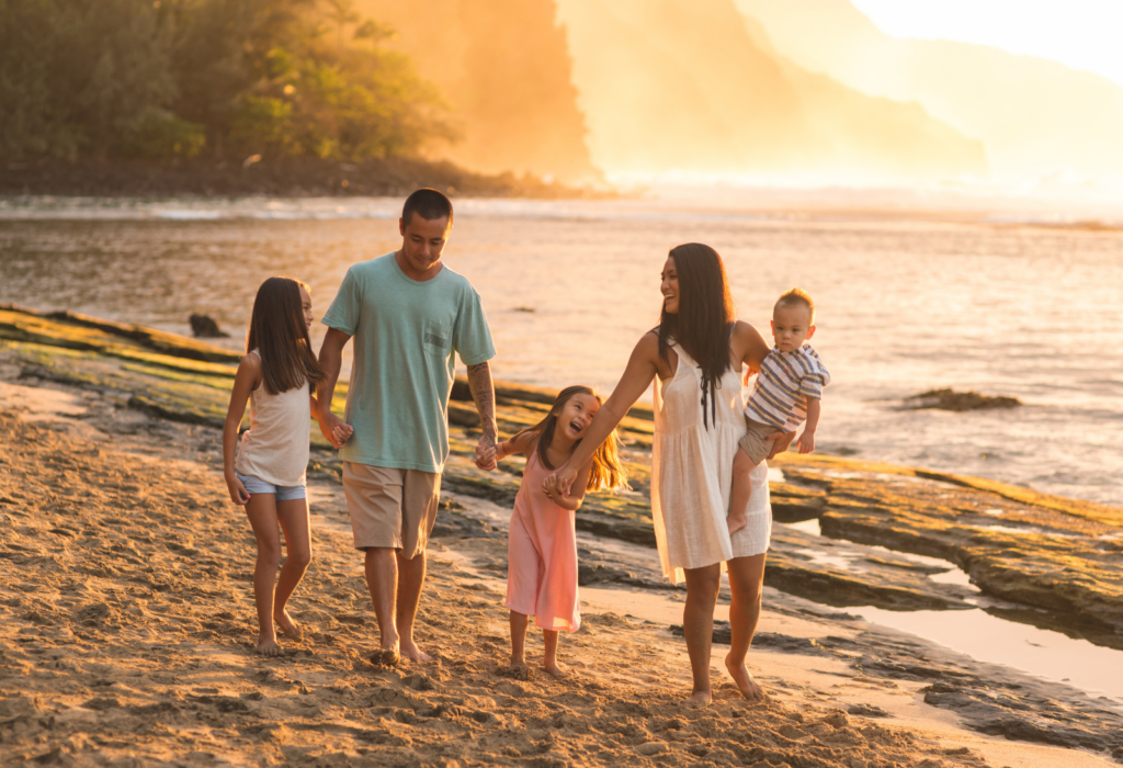 family at beach during sunset