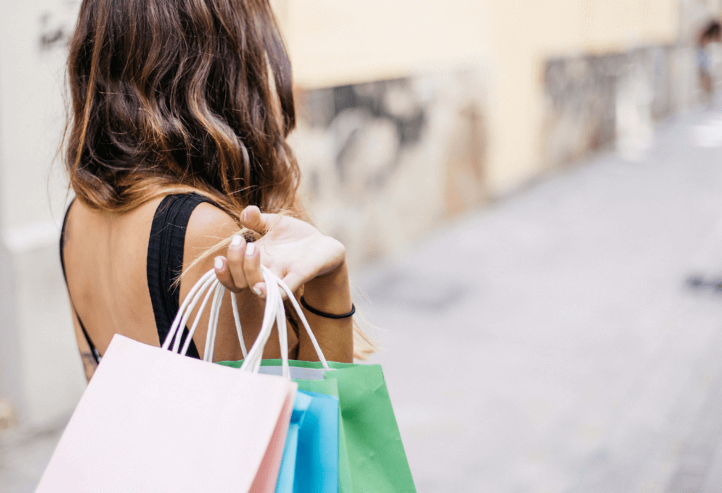 woman with shopping bags in hand, for article on how to choose a bank