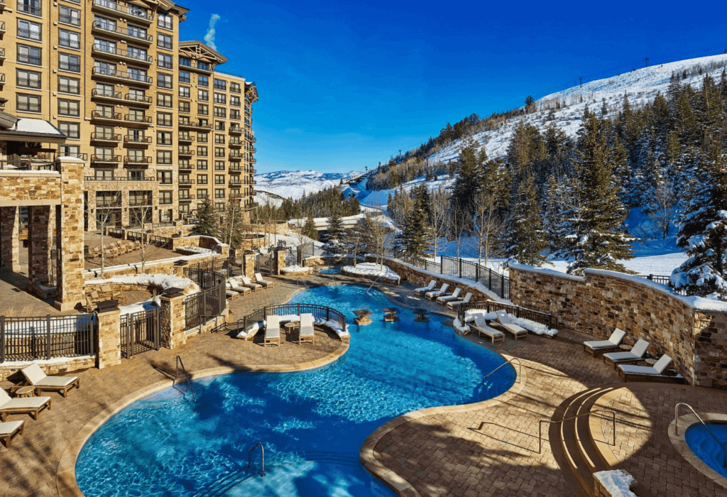 the pool area with snow covered hills nearby at St. Regis Deer Valley