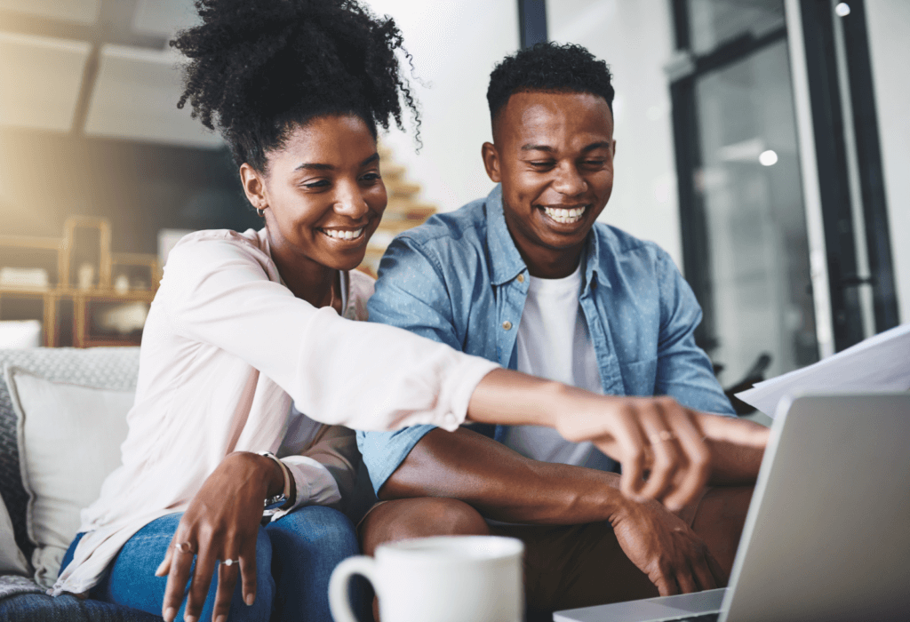 couple sitting on couch looking at computer, for article on how to choose a bank