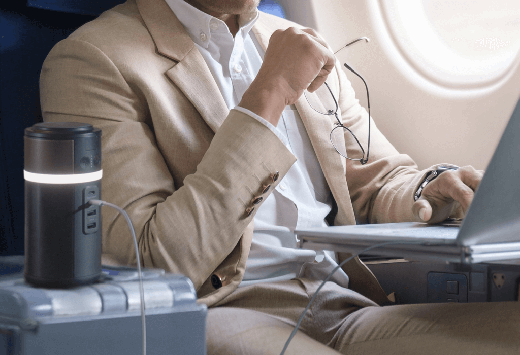 a man using the duracell m150 portable powerstation to work on a plane