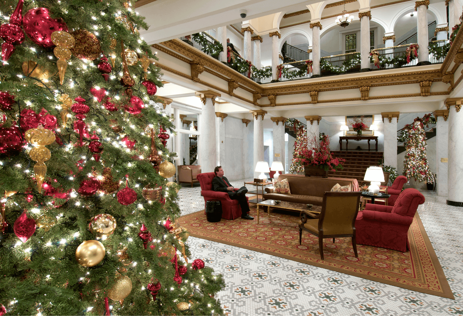 christmas tree sits in a hotel lobby