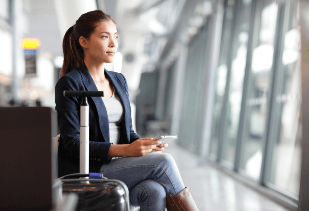 Woman relaxing at an airport as she waits for her flight