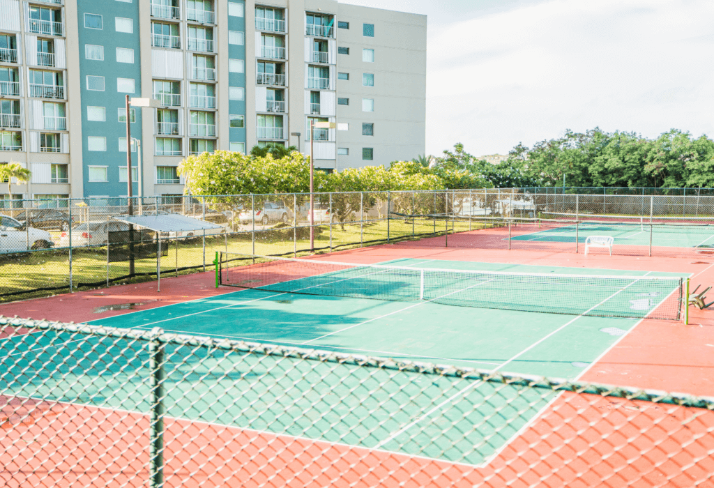 A tennis court outside of a hotel