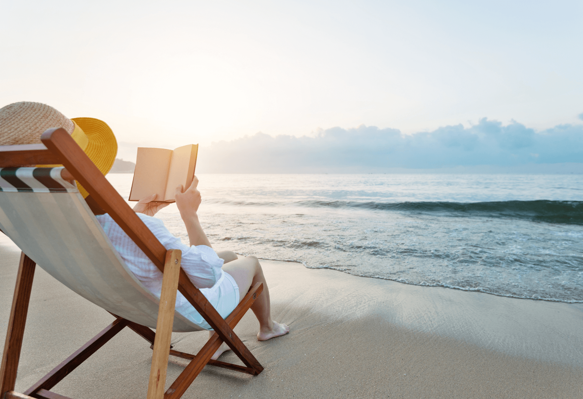 woman reading book on beach for story on priceline vacation deals