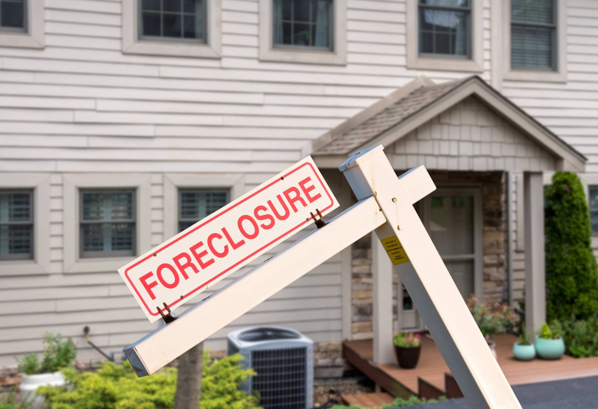 house with foreclosure sign