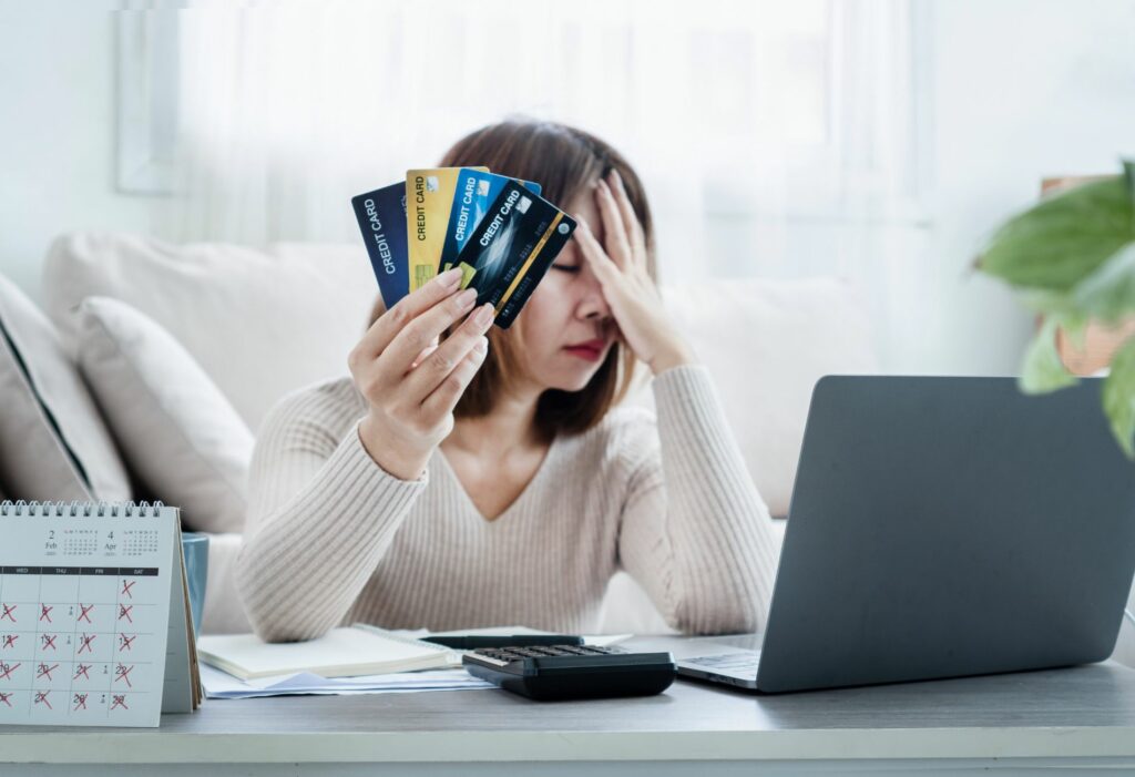 woman with credit cards looking distressed