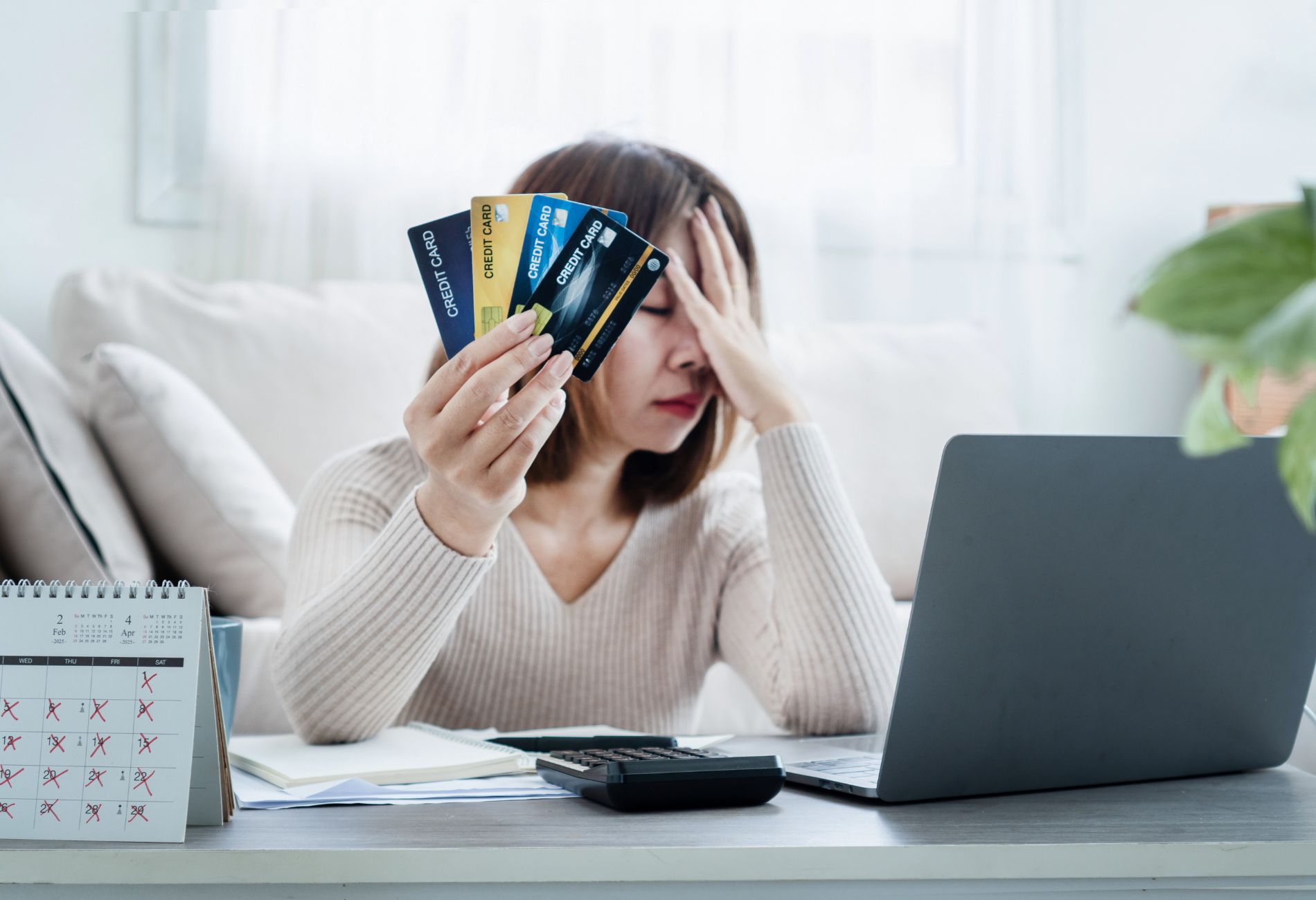woman with credit cards looking distressed