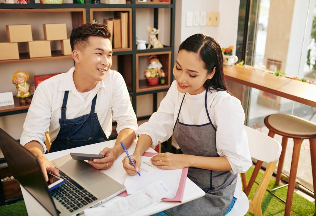 Small business owners looking at a computer